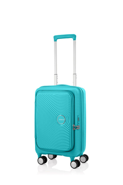 Angled view of the American Tourister Curio Book Opening hard luggage spinner in Turquoise, showcasing its iconic concentric circle "ripple" design on a durable polypropylene shell. Find Now Online