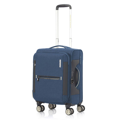 Angled view of the American Tourister Droyce soft-shell spinner in Navy, featuring a modern dip-dye color gradient, grey accents, and a distinctive metal logo. Shop Now Online