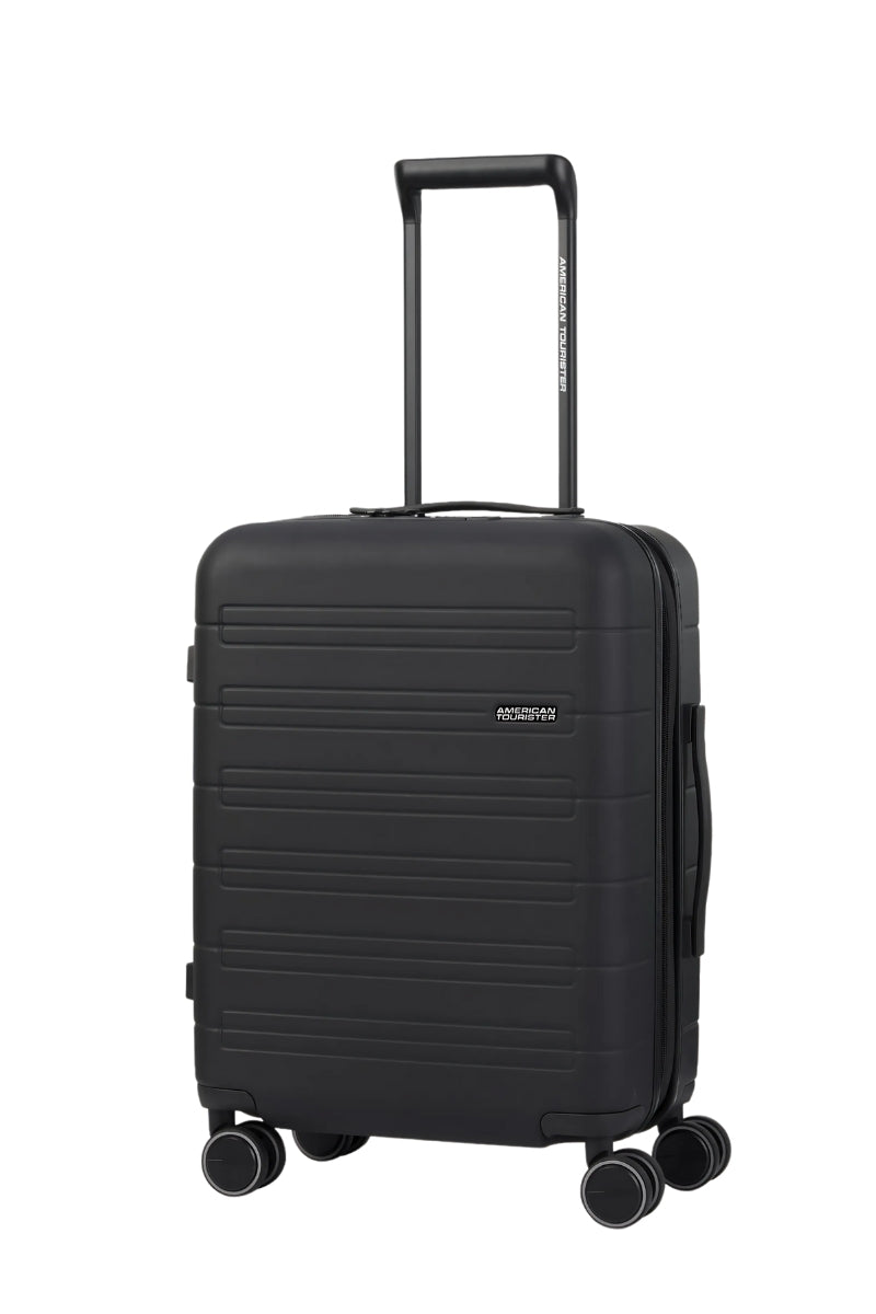 Angled view of the American Tourister Novastream Cabin hard suitcase Luggage in Dark Slate, with ribbed design, TSA lock, and spinner wheels. Order Online Today