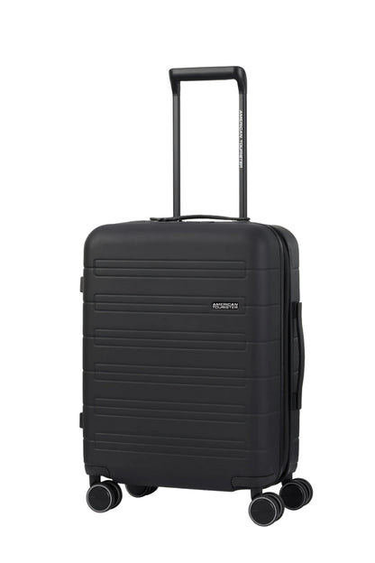Angled view of the American Tourister Novastream Cabin hard suitcase Luggage in Dark Slate, with ribbed design, TSA lock, and spinner wheels. Order Online Today
