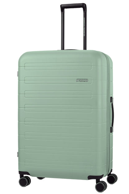 Angled view of the American Tourister Novastream Large hard suitcase Luggage in Nomad Green, with ribbed design, TSA lock, and spinner wheels. Order Online Today