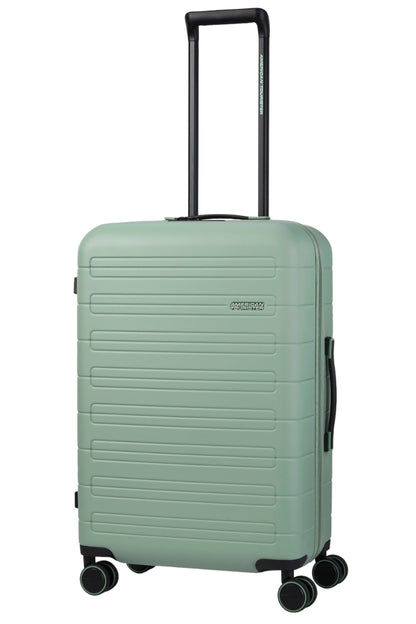 Angled view of the American Tourister Novastream Medium hard suitcase Luggage in Nomad Green, with ribbed design, TSA lock, and spinner wheels. Order Online Today