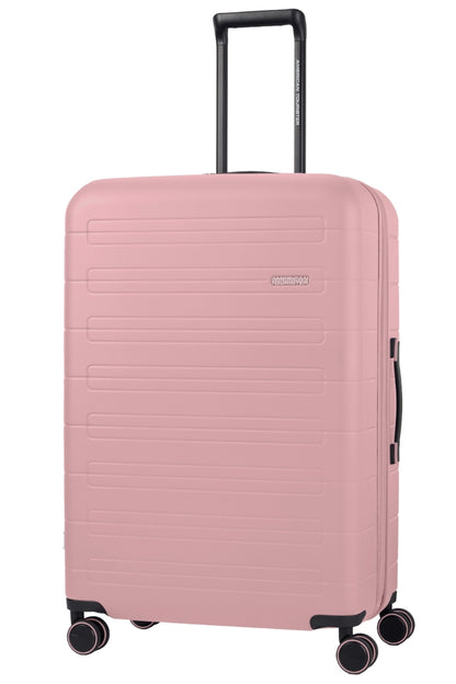 Angled view of the American Tourister Novastream Medium hard suitcase Luggage in Vintage Pink, with ribbed design, TSA lock, and spinner wheels. Order Online Today