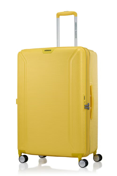 Angled view of the American Tourister Robotech spinner hard luggage in Citron Yellow, showing the sleek textured hardshell and robust double wheels. Shop Online