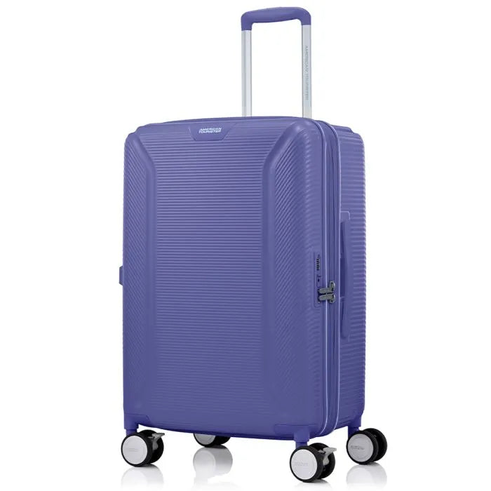 Angled view of the American Tourister Robotech spinner medium hard luggage in Future Dusk, showing the sleek textured hardshell and robust double wheels. Shop Online