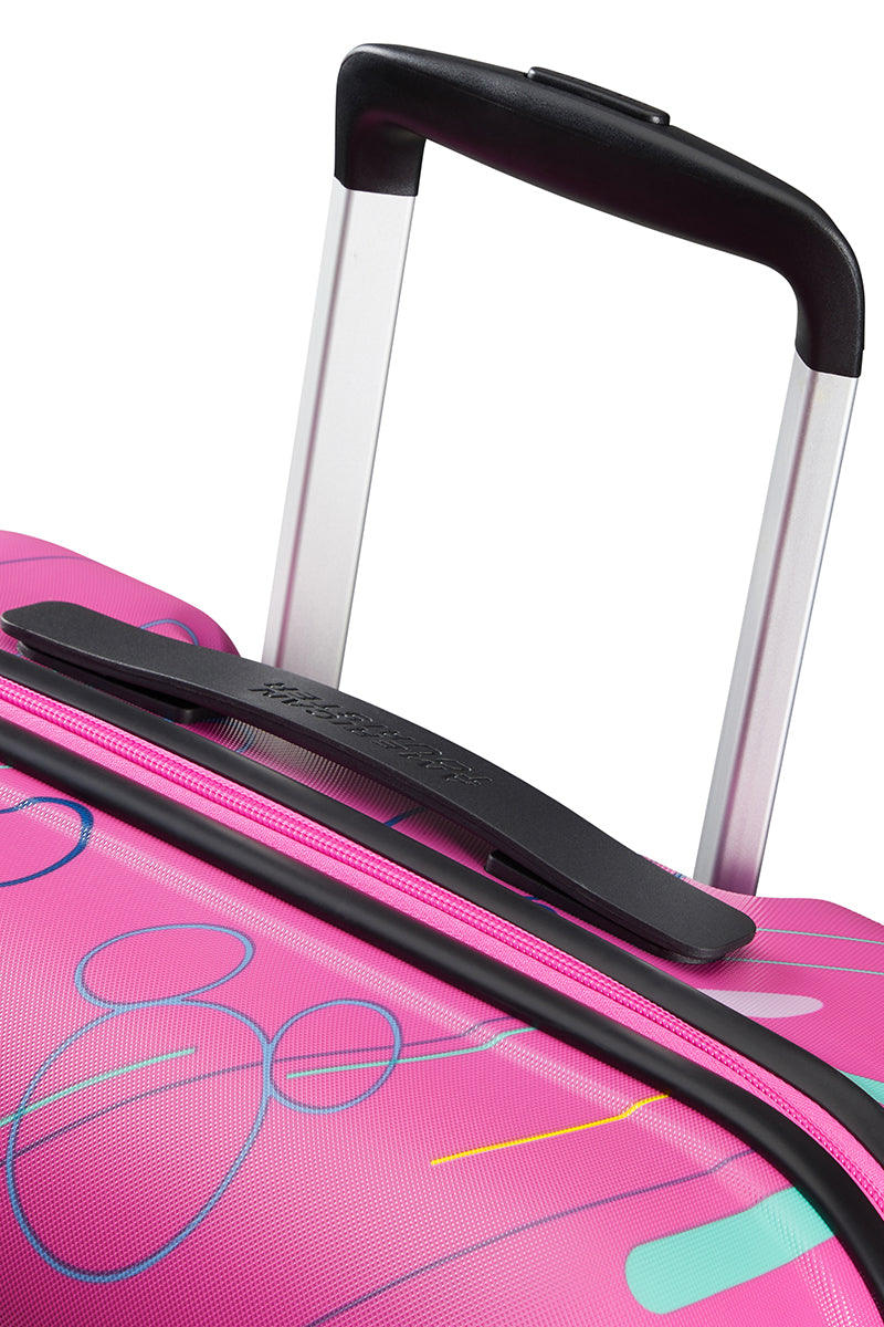 Close-up handle view of the American Tourister Disney Wavebreaker spinner in Pink, showing the expandable and carry handles. Find Now Online