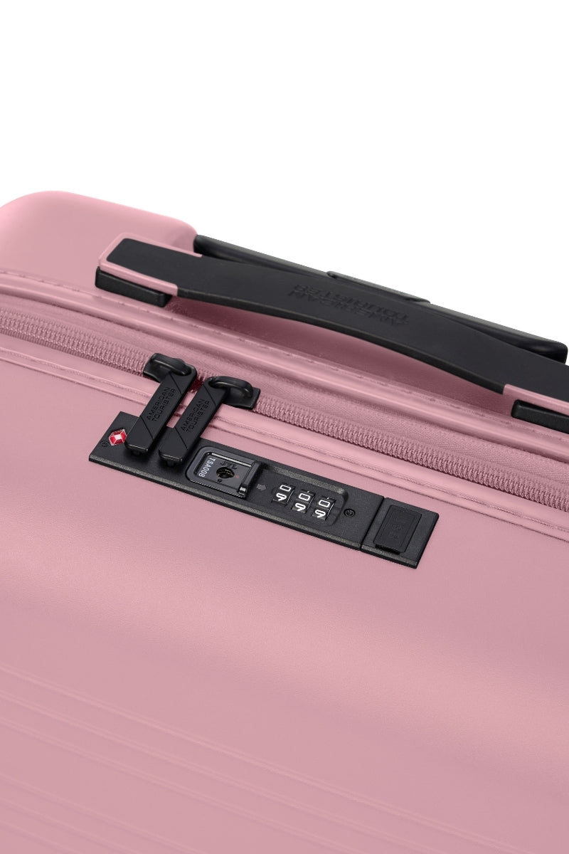 Close-up top view of the American Tourister Novastream hard suitcase Luggage in Vintage Pink, with ribbed design, TSA lock, and spinner wheels. Order Online Today