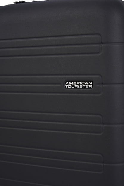 Close-up view of the American Tourister Novastream hard suitcase Luggage in Dark Slate, with ribbed design, TSA lock, and spinner wheels. Order Online Today