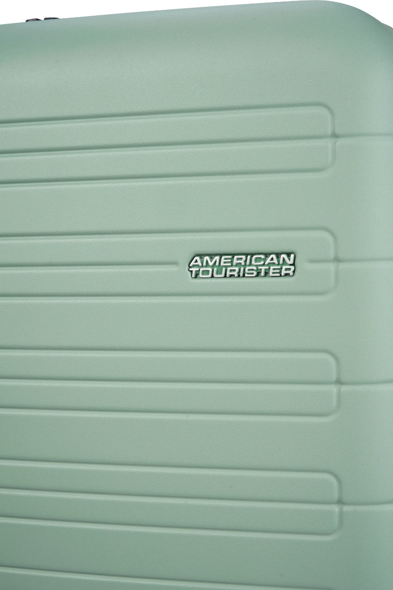 Close-up view of the American Tourister Novastream hard suitcase Luggage in Nomad Green, with ribbed design, TSA lock, and spinner wheels. Order Online Today