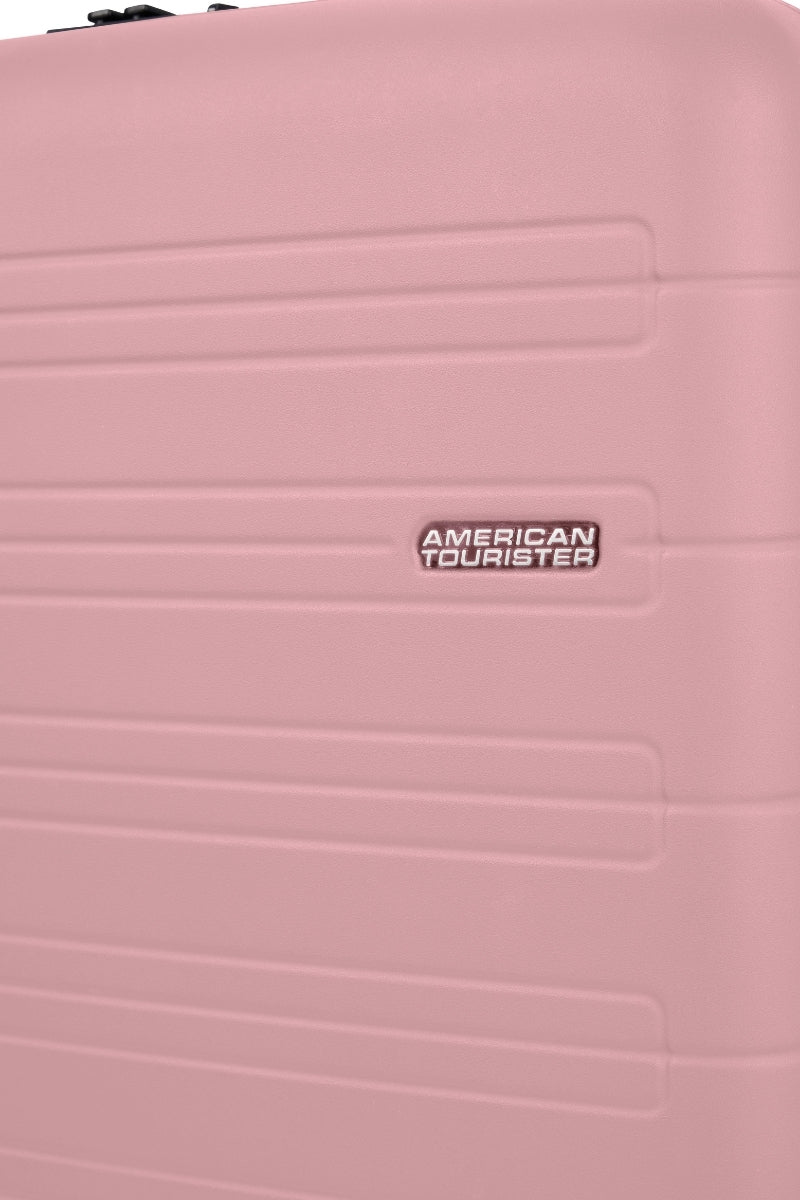 Close-up view of the American Tourister Novastream hard suitcase Luggage in Vintage Pink, with ribbed design, TSA lock, and spinner wheels. Order Online Today