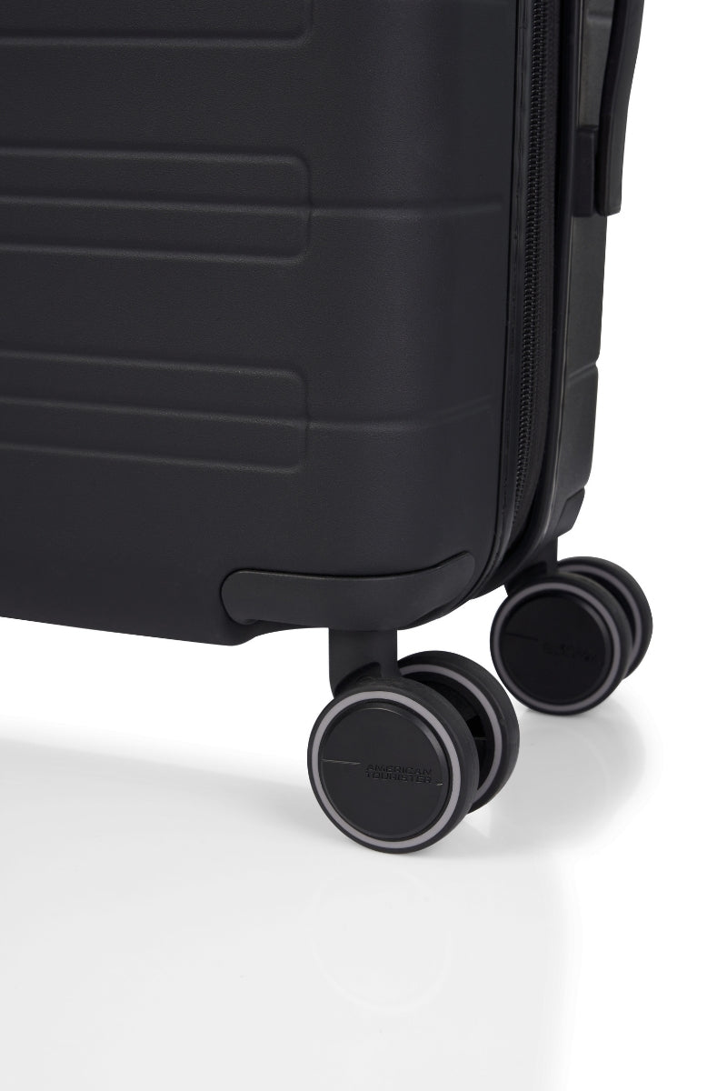 Close-up wheels view of the American Tourister Novastream hard suitcase Luggage in Dark Slate, with ribbed design, TSA lock, and spinner wheels. Order Online Today