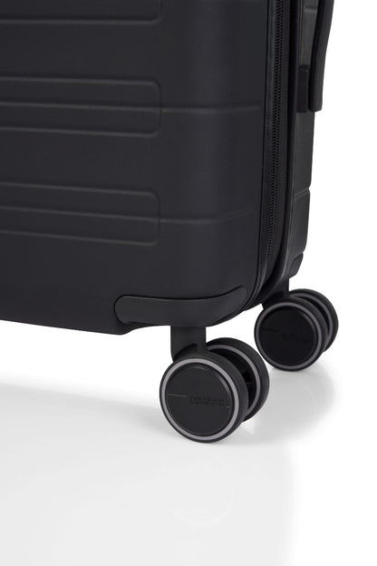 Close-up wheels view of the American Tourister Novastream hard suitcase Luggage in Dark Slate, with ribbed design, TSA lock, and spinner wheels. Order Online Today