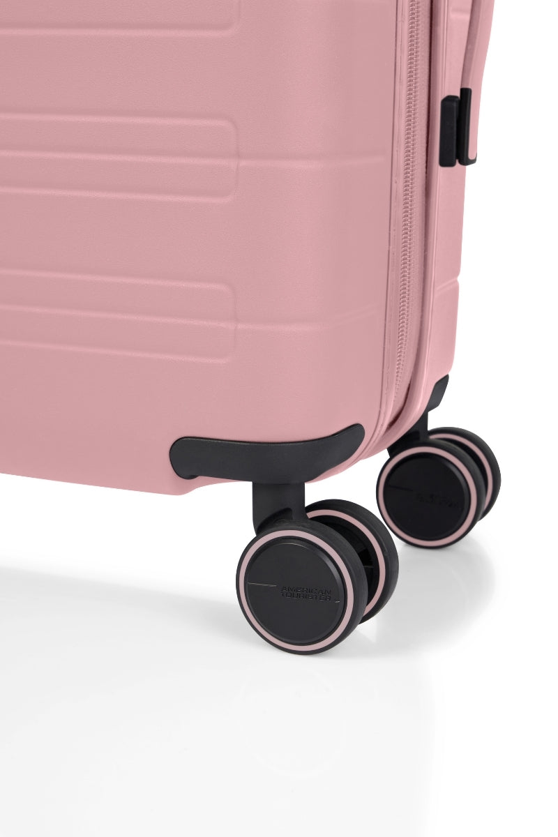 Close-up wheels view of the American Tourister Novastream hard suitcase Luggage in Vintage Pink, with ribbed design, TSA lock, and spinner wheels. Order Online Today
