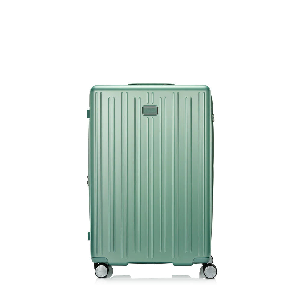 Front view of the American Tourister Reggio hard luggage in Green, highlighting its modern textured shell and smooth double spinner wheels. Available Now Online