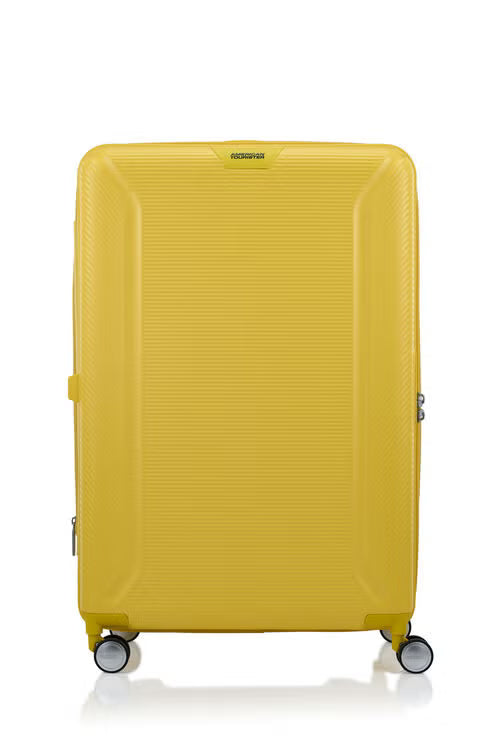 Front view of the American Tourister Robotech spinner hard luggage in Citron Yellow, showing the sleek textured hardshell and robust double wheels. Shop Online