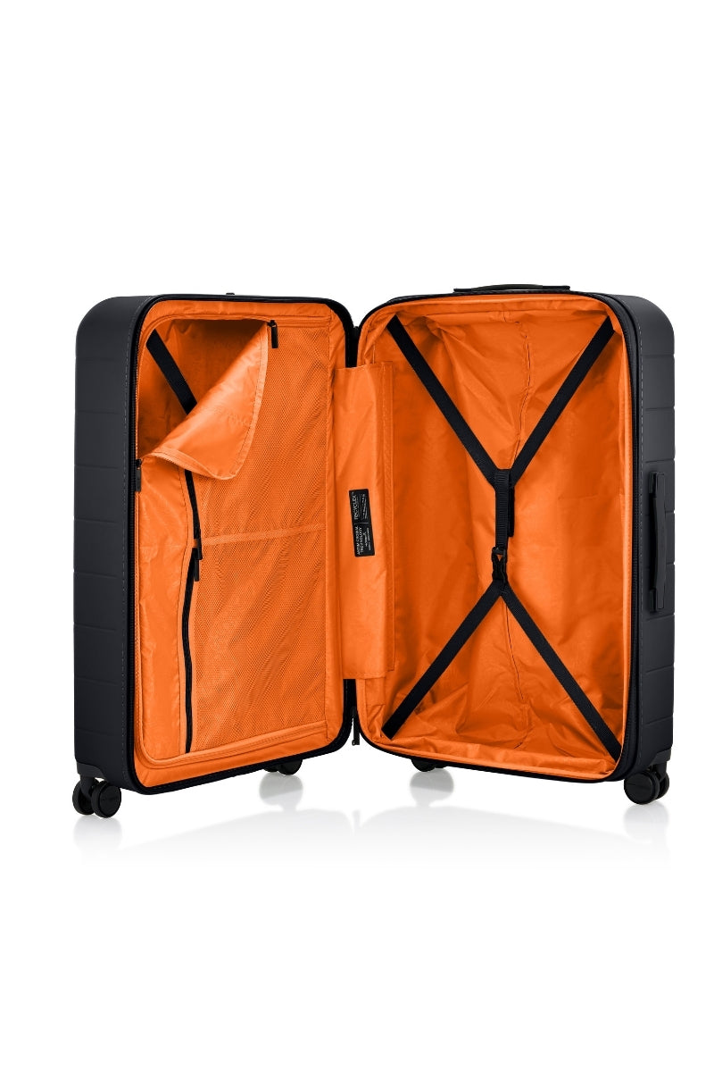 Inside view of the opened American Tourister Novastream Medium hard suitcase Luggage in Dark Slate, with ribbed design, TSA lock, and spinner wheels. Order Online Today