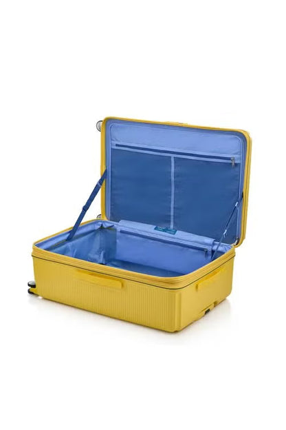 Interior view of the American Tourister Robotech spinner hard luggage in Citron Yellow with Blue interior, showing the sleek textured hardshell and robust double wheels. Shop Online