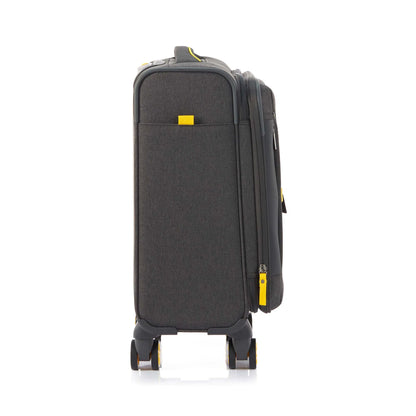 Other side view of the American Tourister Droyce soft-shell spinner in Grey, featuring a modern dip-dye color gradient, yellow accents, and a distinctive metal logo. Shop Now Online
