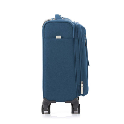 Other side view of the American Tourister Droyce soft-shell spinner in Navy, featuring a modern dip-dye color gradient, grey accents, and a distinctive metal logo. Shop Now Online