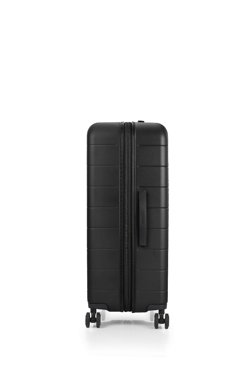 Other side view of the American Tourister Novastream Medium hard suitcase Luggage in Dark Slate, with ribbed design, TSA lock, and spinner wheels. Order Online Today