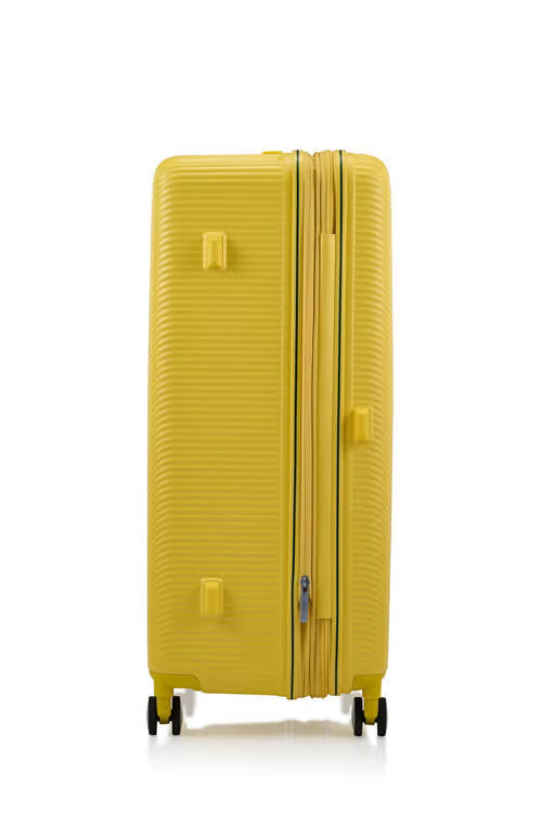 Other side view of the American Tourister Robotech spinner hard luggage in Citron Yellow, showing the sleek textured hardshell and robust double wheels. Shop Online