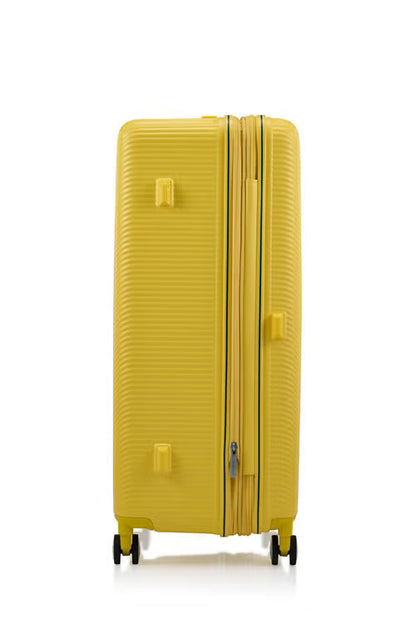 Other side view of the American Tourister Robotech spinner hard luggage in Citron Yellow, showing the sleek textured hardshell and robust double wheels. Shop Online