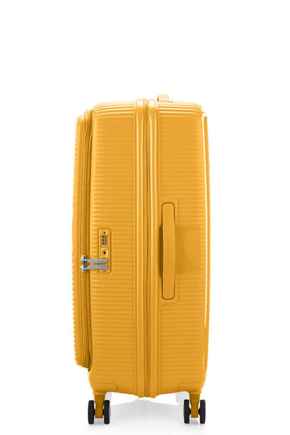 Side view of the American Tourister Curio Book Opening hard luggage spinner in Yellow, showcasing the zippers and the durable polypropylene shell. Find Now Online