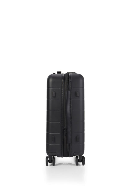 Side view of the American Tourister Novastream Cabin hard suitcase Luggage in Dark Slate, with ribbed design, TSA lock, and spinner wheels. Order Online Today