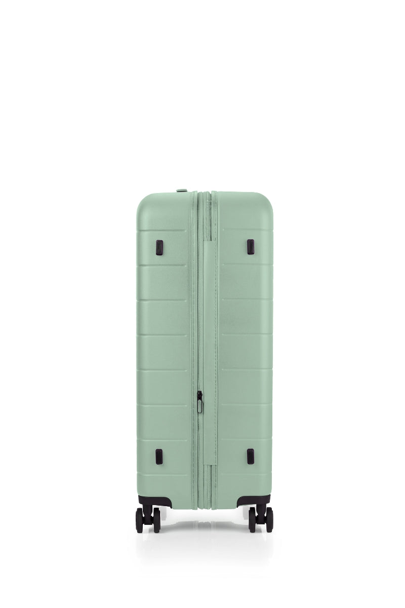 Side view of the American Tourister Novastream hard suitcase Luggage in Nomad Green, with ribbed design, TSA lock, and spinner wheels. Order Online Today