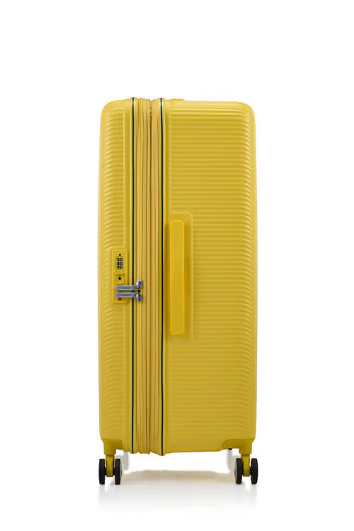 Side view of the American Tourister Robotech spinner hard luggage in Citron Yellow, showing the sleek textured hardshell and robust double wheels. Shop Online