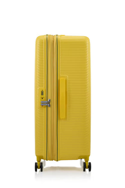 Side view of the American Tourister Robotech spinner hard luggage in Citron Yellow, showing the sleek textured hardshell and robust double wheels. Shop Online